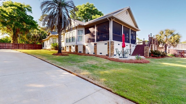 406 Scenic Rt, Cordele, GA 31015 - view of front of house with fence, a sunroom, a front yard, and stairway