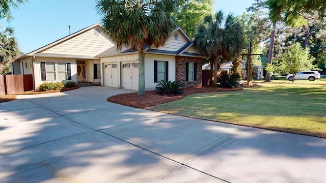 406 Scenic Rt, Cordele, GA 31015 - ranch-style home featuring a garage, concrete driveway, stone siding, fence, and a front yard