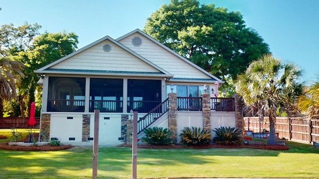 406 Scenic Rt, Cordele, GA 31015 - view of front facade featuring a front lawn, stone siding, fence, stairway, and a sunroom