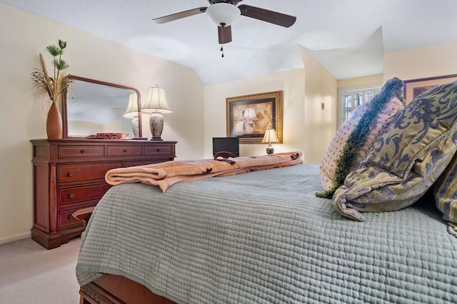 bedroom with ceiling fan, light colored carpet, and lofted ceiling