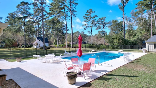 view of swimming pool with a patio area, a lawn, and a diving board