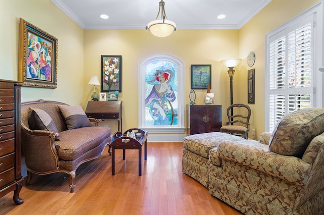 living area featuring wood-type flooring and crown molding