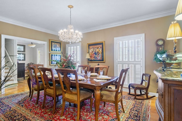 dining area with crown molding, plenty of natural light, and light hardwood / wood-style flooring