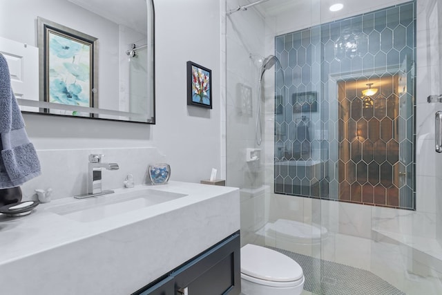 bathroom with crown molding, toilet, a shower with shower door, and vanity