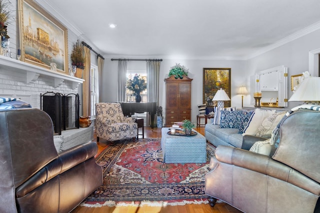 living room with ornamental molding, hardwood / wood-style floors, and a fireplace