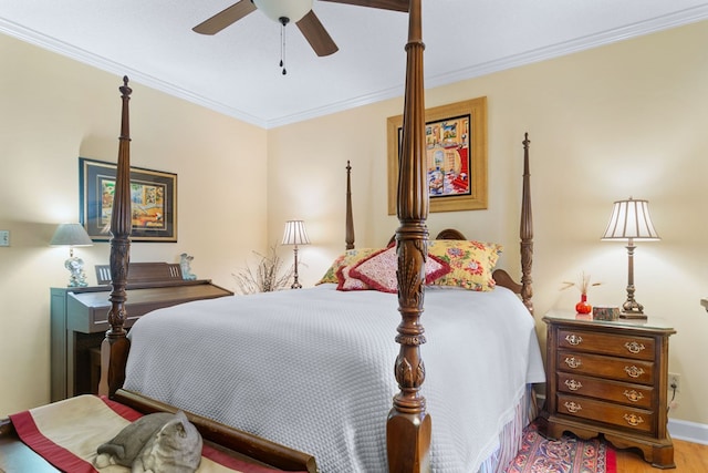 bedroom with hardwood / wood-style floors, ceiling fan, and ornamental molding