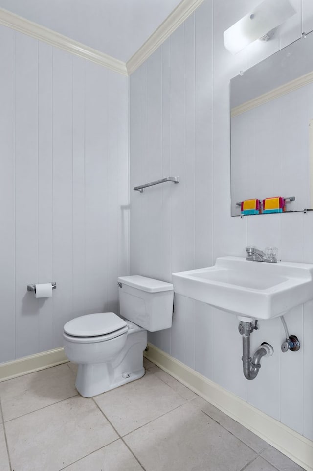 bathroom with tile patterned floors, toilet, and crown molding