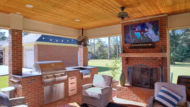 view of patio / terrace with exterior kitchen, an outdoor brick fireplace, and grilling area