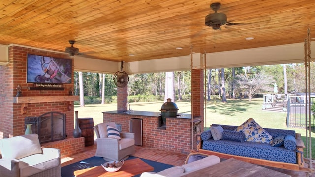 view of patio with exterior kitchen, an outdoor living space with a fireplace, and ceiling fan