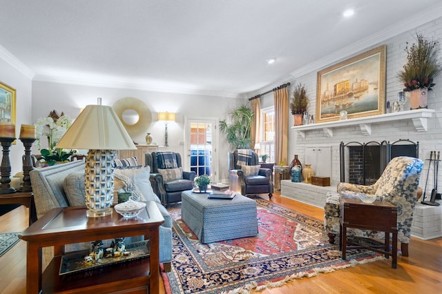 living room with a fireplace, hardwood / wood-style flooring, and ornamental molding