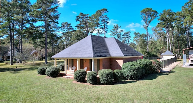 view of side of property with a lawn