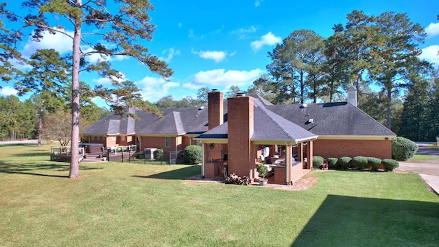 back of property with outdoor lounge area, cooling unit, a lawn, and a patio