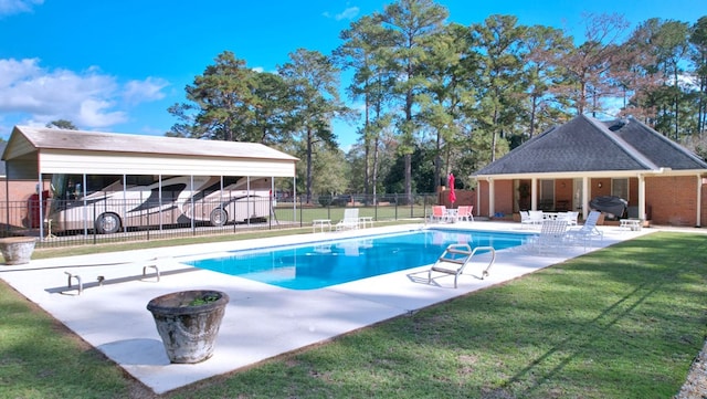 view of swimming pool with a diving board, a yard, grilling area, and a patio