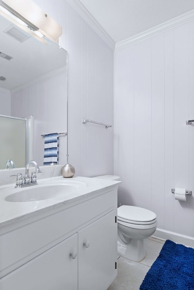 bathroom featuring toilet, crown molding, a textured ceiling, an enclosed shower, and tile patterned flooring