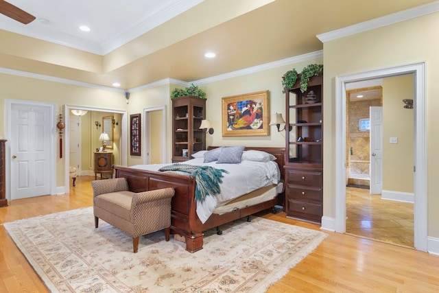 bedroom featuring ceiling fan, connected bathroom, light hardwood / wood-style flooring, and ornamental molding