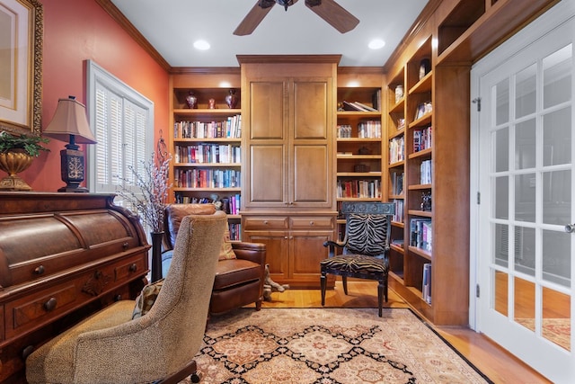 sitting room featuring light hardwood / wood-style floors, ceiling fan, and ornamental molding