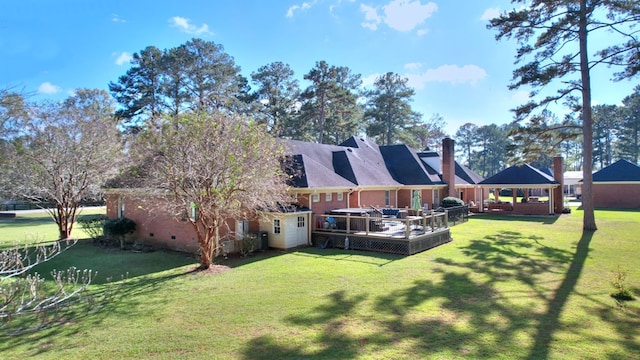 back of house featuring a gazebo and a yard