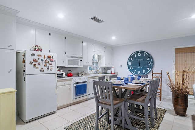 kitchen featuring white cabinetry, white appliances, light tile patterned floors, and ornamental molding