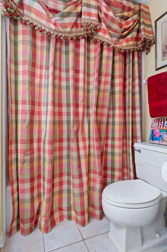 bathroom featuring toilet and tile patterned flooring