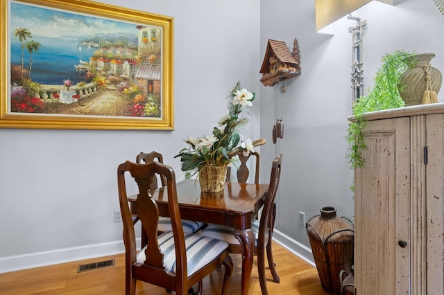 dining area with hardwood / wood-style floors