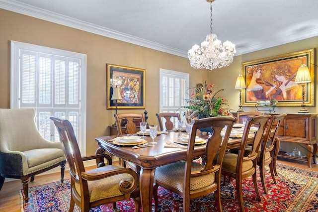 dining room with a notable chandelier, crown molding, and wood-type flooring