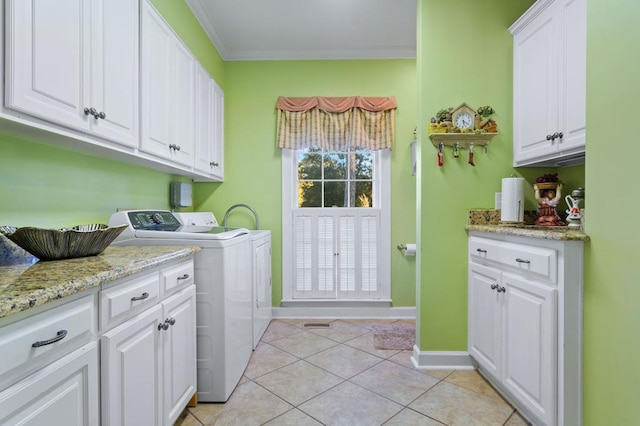 laundry area with crown molding, cabinets, separate washer and dryer, and light tile patterned flooring