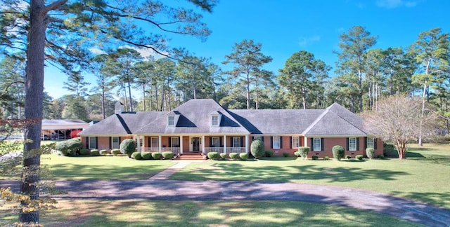 view of front of home with covered porch and a front yard