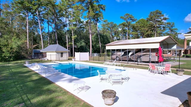 view of pool featuring a diving board and a lawn