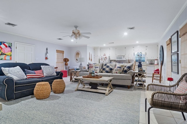 living room with crown molding, light tile patterned floors, and ceiling fan