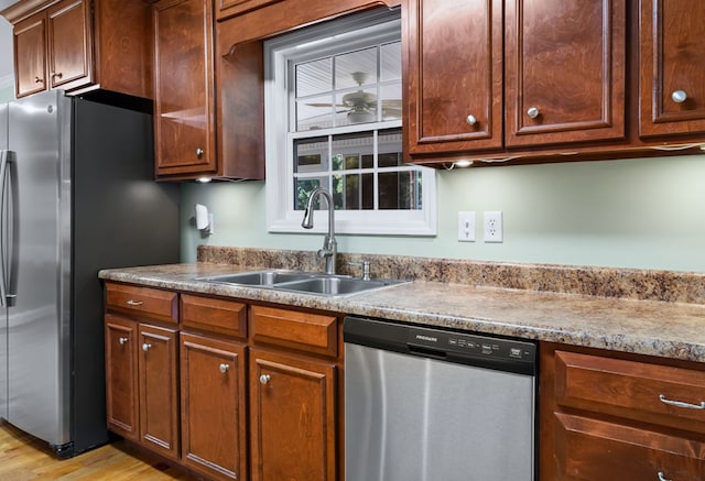 kitchen featuring sink, appliances with stainless steel finishes, and light wood-type flooring