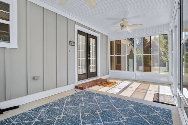 unfurnished sunroom with ceiling fan