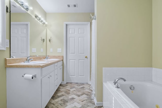 bathroom with a relaxing tiled tub and vanity