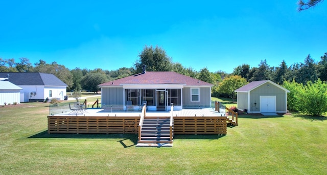 back of house featuring a storage unit, a deck, and a yard