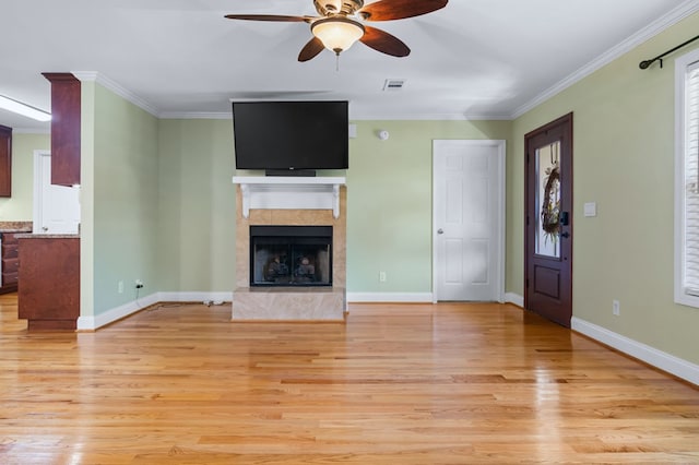 unfurnished living room featuring light hardwood / wood-style flooring, ceiling fan, and ornamental molding