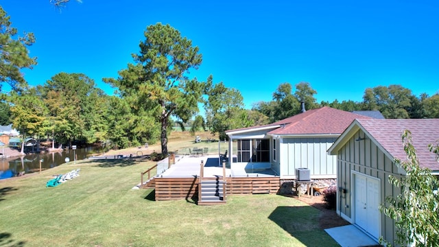 view of yard with a deck with water view, cooling unit, and a sunroom