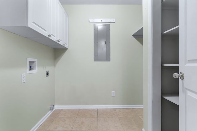 washroom with electric dryer hookup, hookup for a washing machine, electric panel, light tile patterned flooring, and cabinets