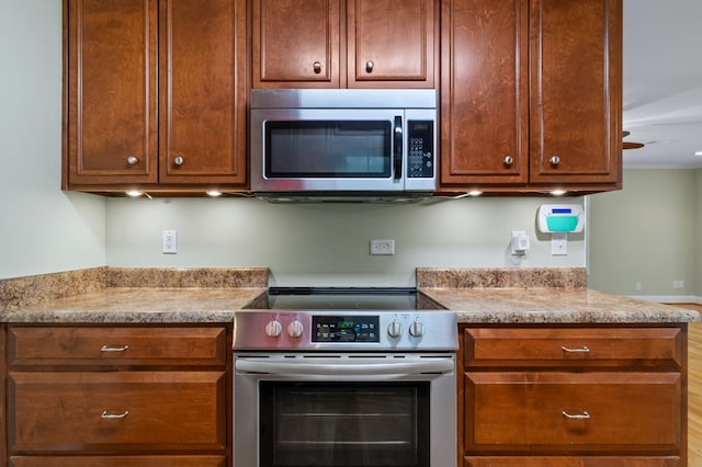 kitchen featuring light stone countertops and stainless steel appliances