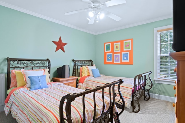 carpeted bedroom with baseboards, ornamental molding, and a ceiling fan