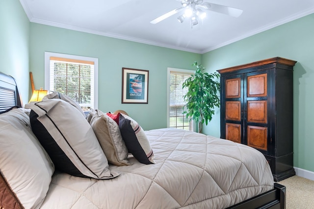 bedroom with ornamental molding, carpet flooring, ceiling fan, and baseboards