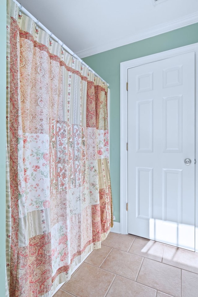 bathroom with crown molding and tile patterned floors