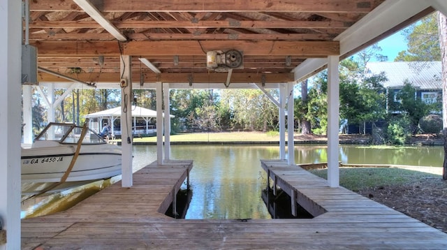 dock area with a water view and boat lift