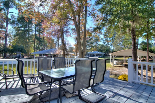 wooden terrace featuring outdoor dining space