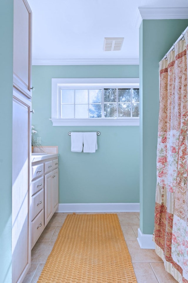 full bathroom featuring visible vents, baseboards, ornamental molding, tile patterned floors, and vanity