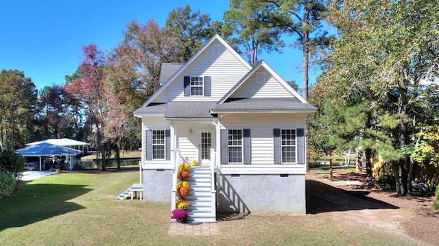 exterior space with a shingled roof, a lawn, and stairway