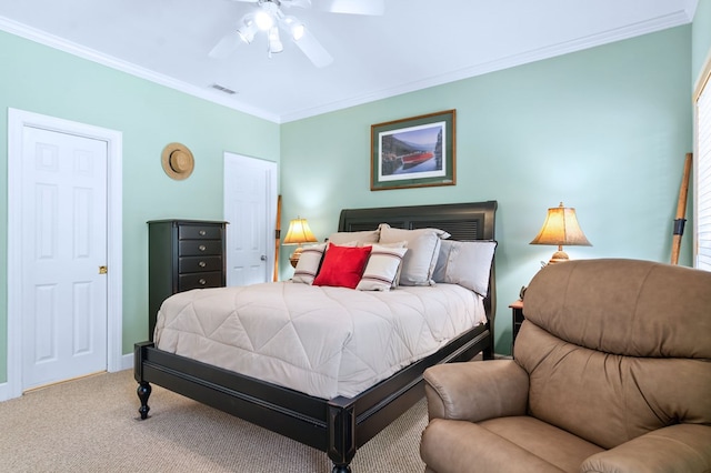 carpeted bedroom featuring ornamental molding, visible vents, ceiling fan, and baseboards