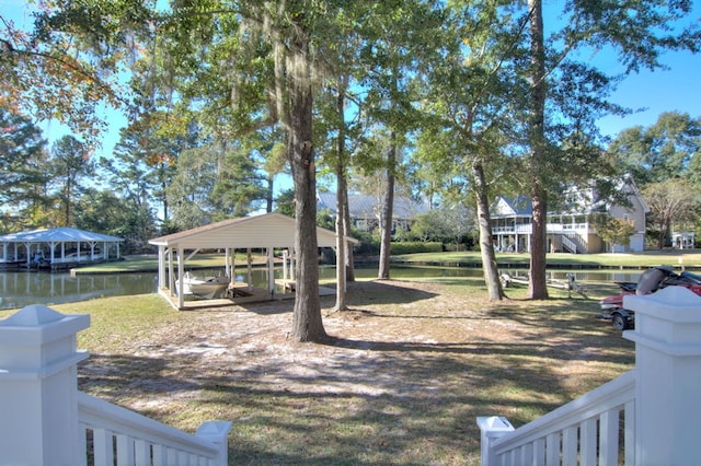 view of yard featuring a carport and a water view