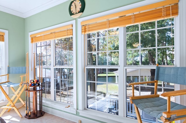 entryway featuring a water view, crown molding, and tile patterned floors