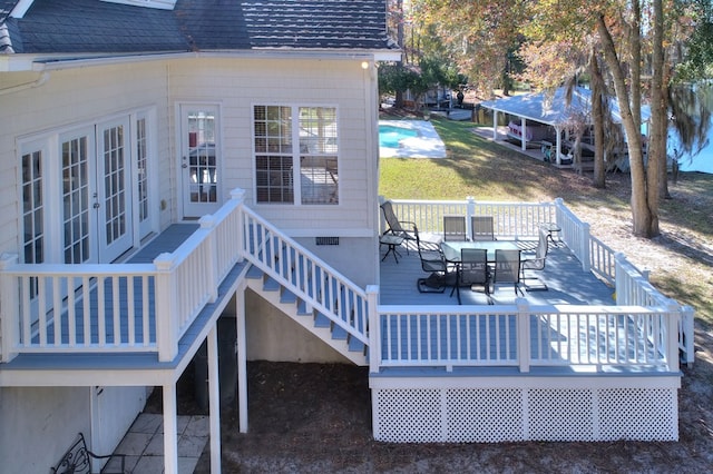 deck with french doors and outdoor dining space