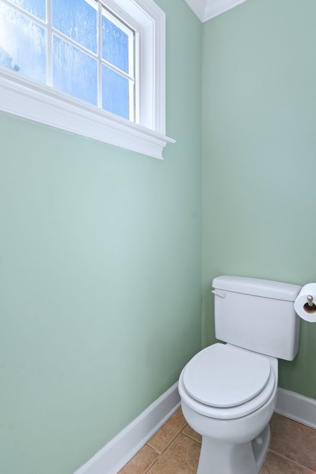 bathroom with toilet, tile patterned flooring, and baseboards