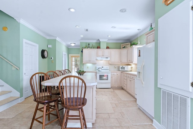 kitchen with under cabinet range hood, white appliances, visible vents, light countertops, and decorative backsplash